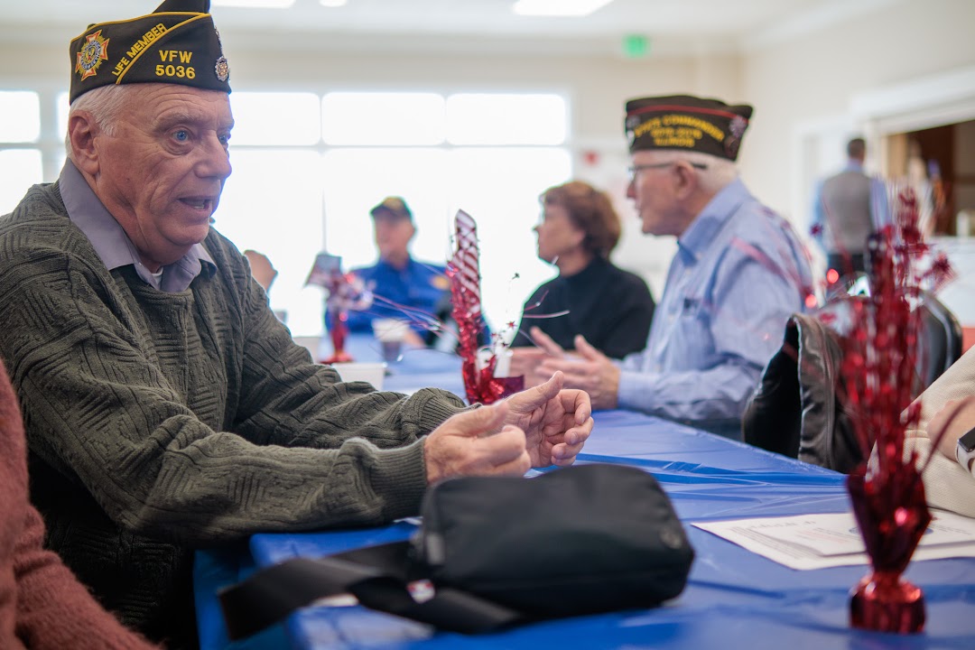 A Post 5036 veteran talks with a student during a Patriot's Pen gathering